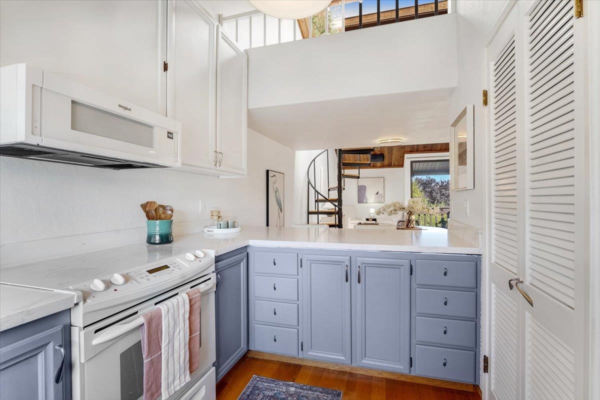 113 Tree Frog Lane Santa Cruz, CA 95060 - Photo 11 of 49 a kitchen with granite countertop white cabinets and window