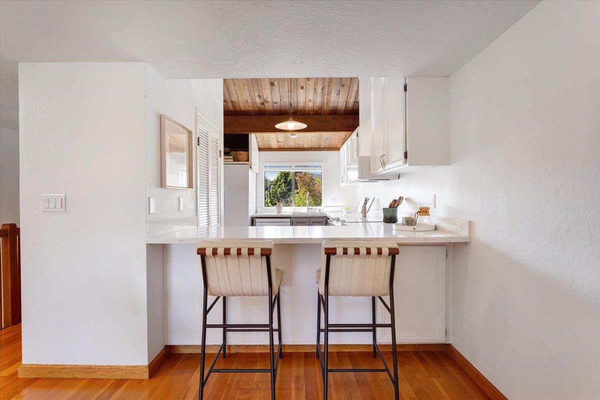 113 Tree Frog Lane Santa Cruz, CA 95060 - Photo 7 of 49 a kitchen with stainless steel appliances a table and chairs in it