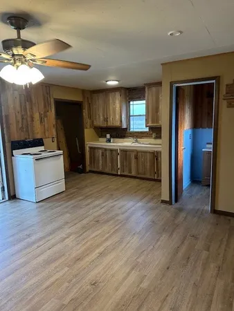 a large kitchen with a stove a sink and a refrigerator