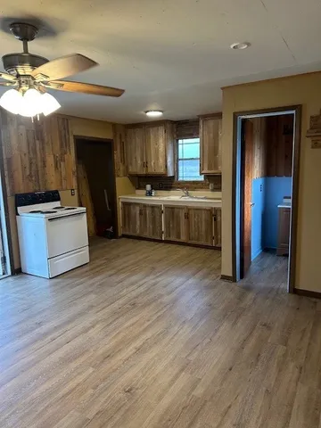 a large kitchen with a stove a sink and a refrigerator