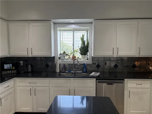 a kitchen with a sink and cabinets