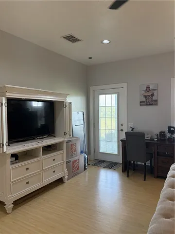 a bedroom with a bed and ceiling chandelier