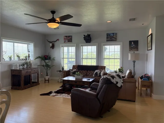 a living room with furniture window and wooden floor