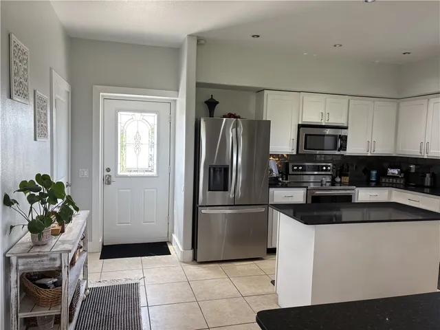 a kitchen with a refrigerator sink and microwave
