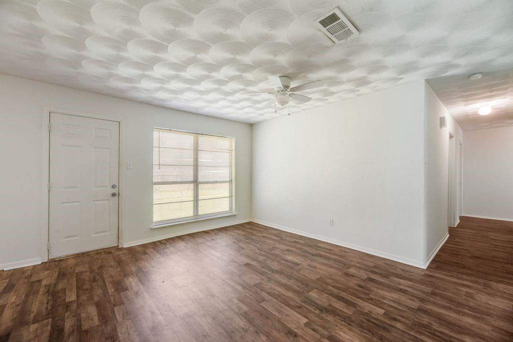 311 Azalea Lane Duncanville, TX 75137 - Photo 11 of 21 a view of an empty room with wooden floor and a window
