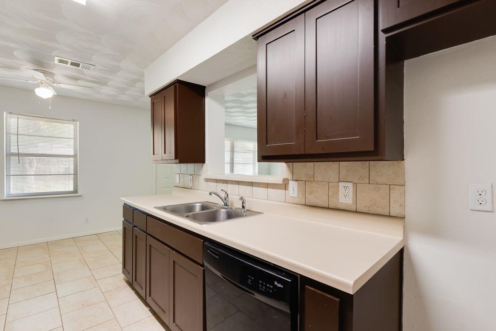 311 Azalea Lane Duncanville, TX 75137 - Photo 14 of 21 a kitchen with a sink cabinets and window