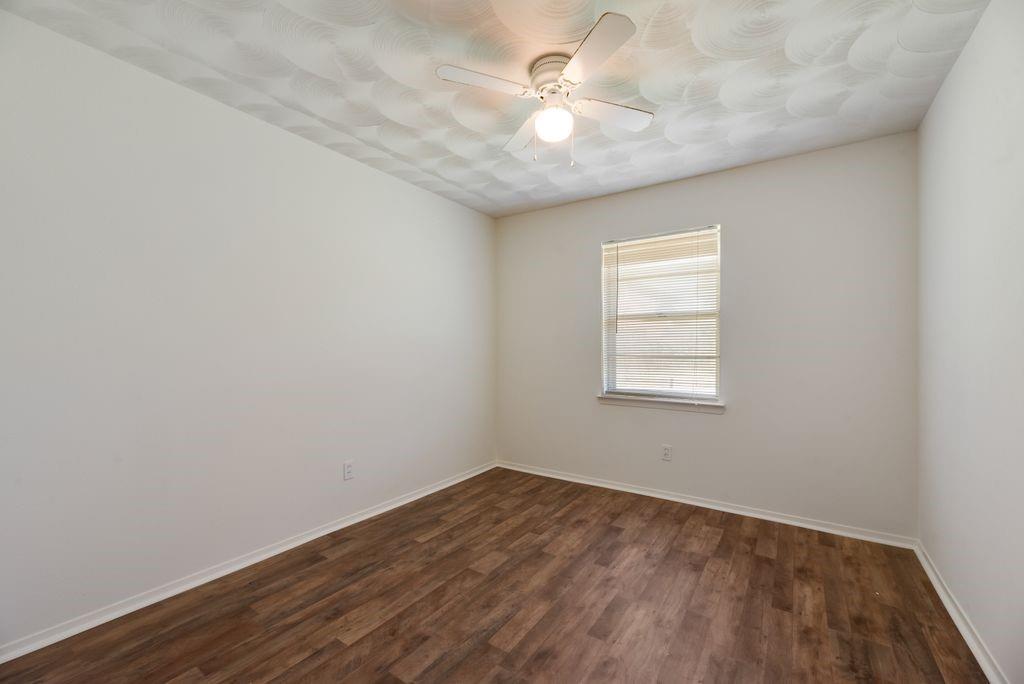 311 Azalea Lane Duncanville, TX 75137 - Photo 15 of 21 an empty room with a window and a fan
