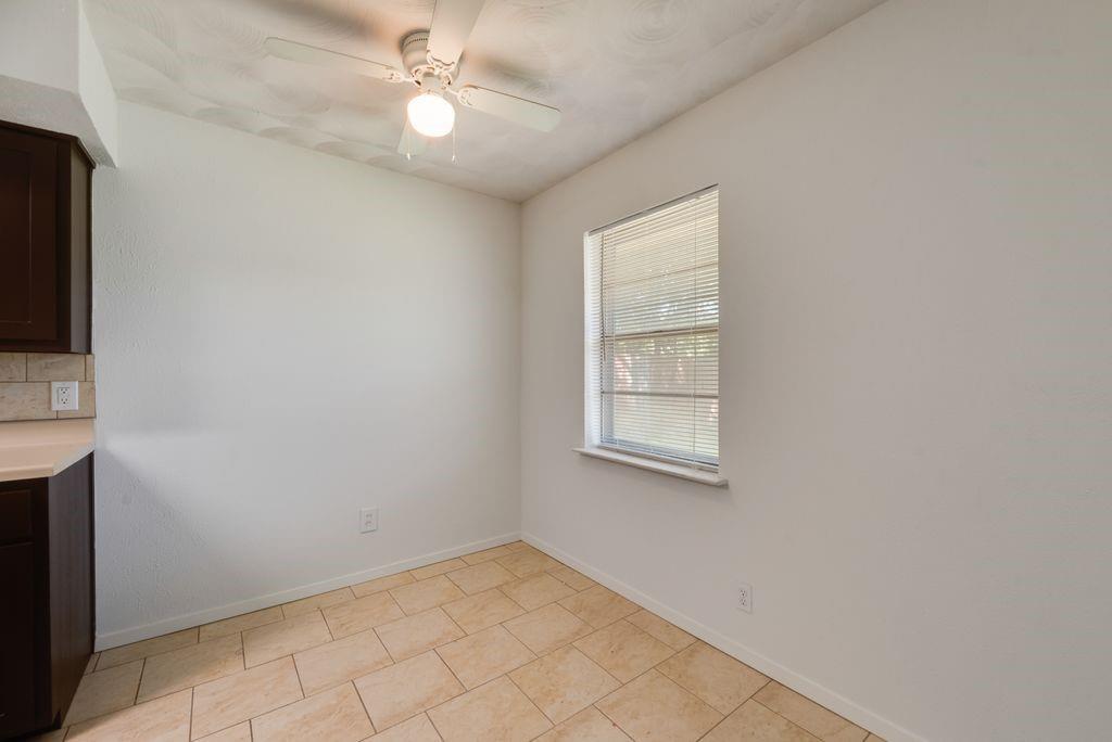 311 Azalea Lane Duncanville, TX 75137 - Photo 17 of 21 an empty room with chandelier fan and windows