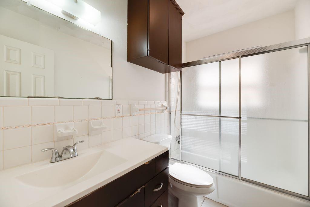 311 Azalea Lane Duncanville, TX 75137 - Photo 18 of 21 a bathroom with a sink toilet and shower