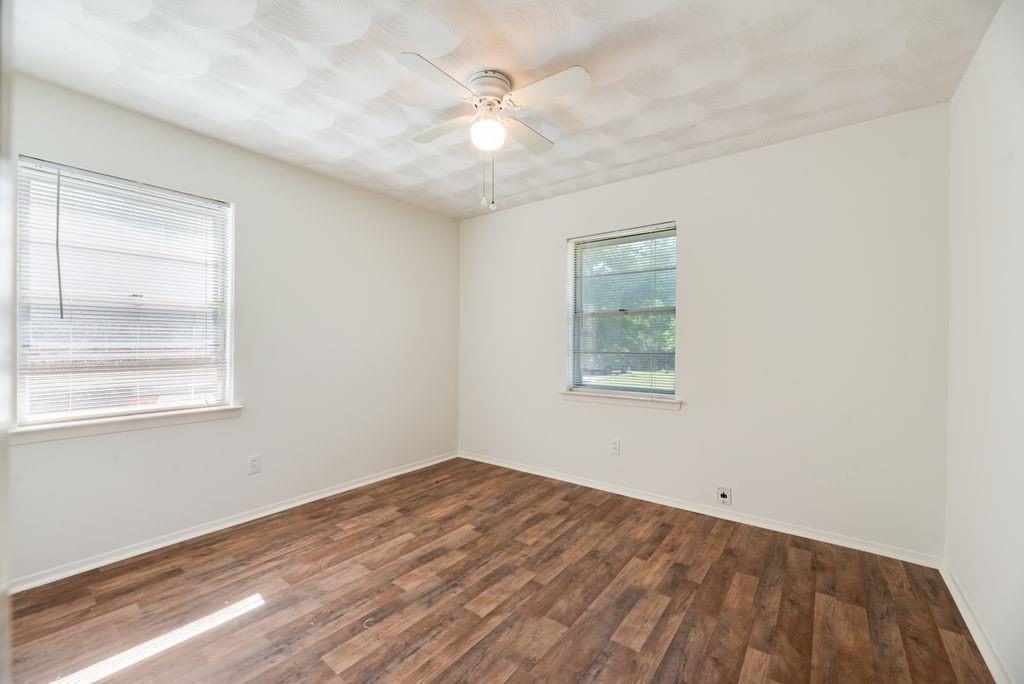 311 Azalea Lane Duncanville, TX 75137 - Photo 19 of 21 an empty room with windows and fan