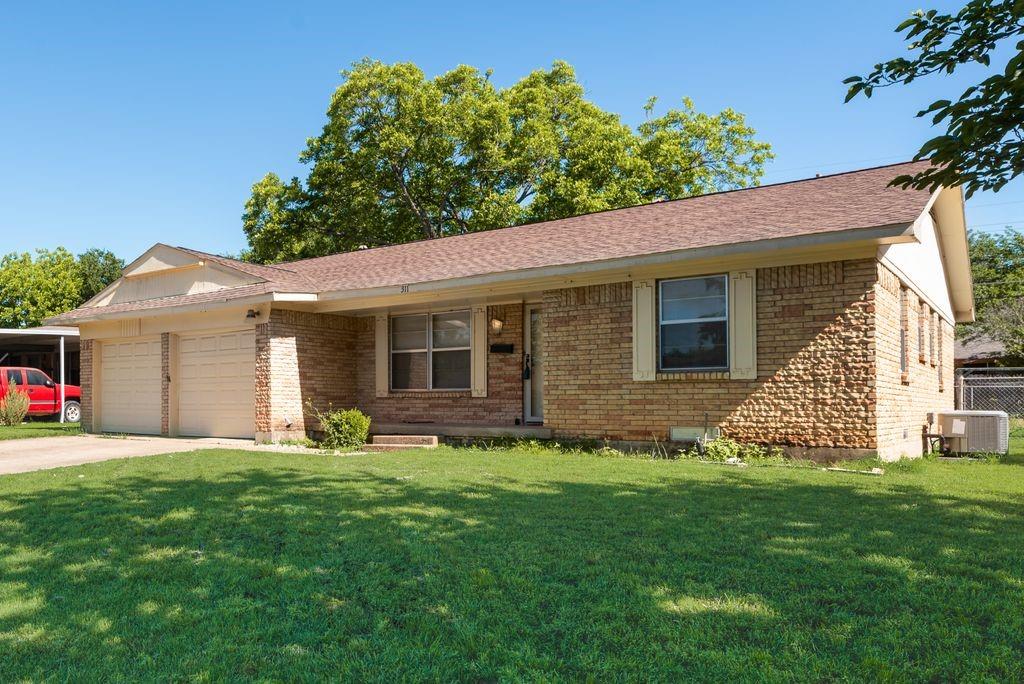 311 Azalea Lane Duncanville, TX 75137 - Photo 4 of 21 a front view of a house with a yard and garage