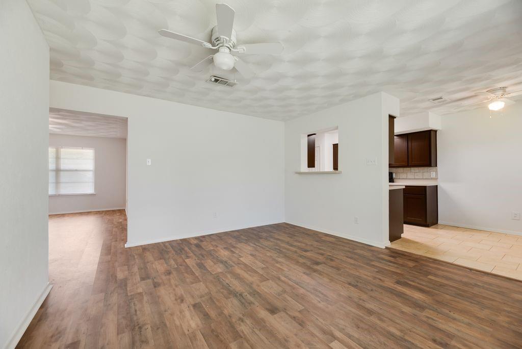 311 Azalea Lane Duncanville, TX 75137 - Photo 10 of 21 a view of empty room with wooden floor and fireplace