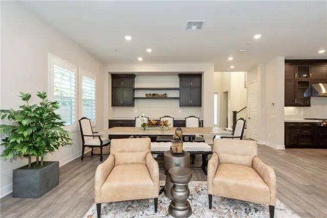 a living room with furniture a flat screen tv and a large window