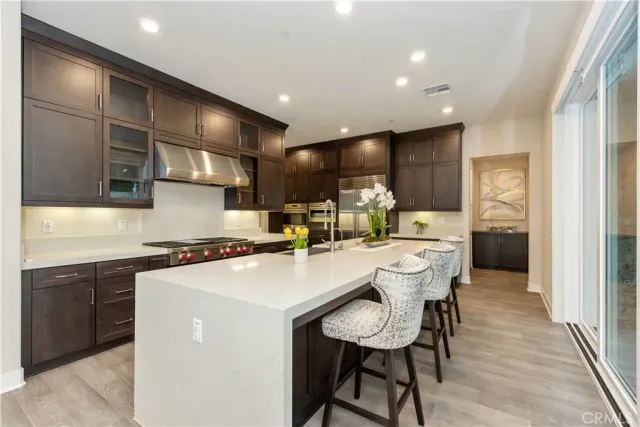 a kitchen with kitchen island a sink table and chairs