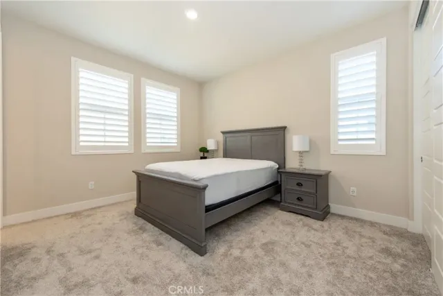 a spacious bathroom with a granite countertop sink mirror and a bathtub