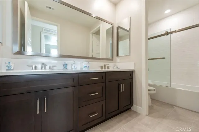 a spacious bathroom with a tub sink shower and mirror