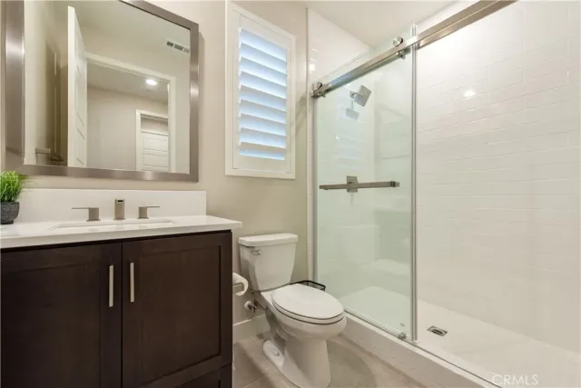 a bathroom with a shower and a toilet