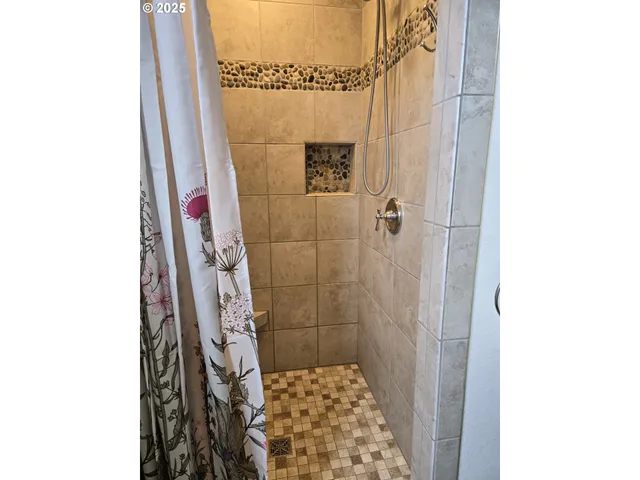 a bathroom with a shower and a sink