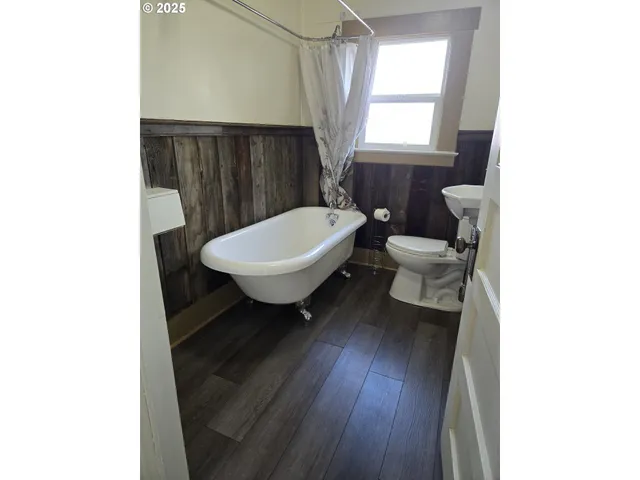 a living room with a toilet and a window