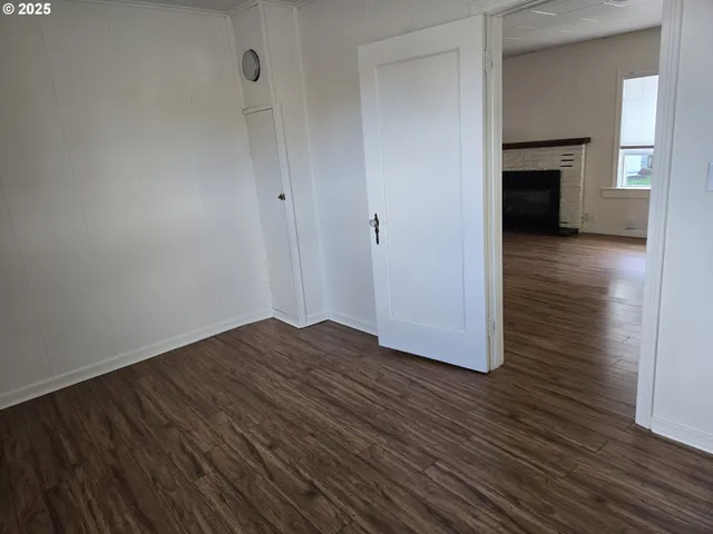 a view of a room with wooden floor and brick wall