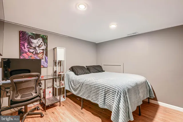 a bedroom with a bed and a desk