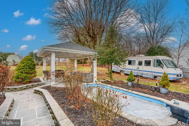 a front view of a house with swimming pool and glass windows