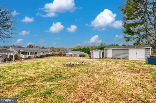 a view of a house with a yard and swimming pool