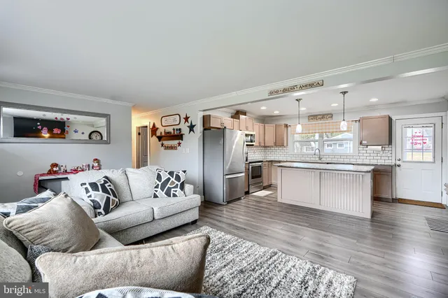a living room with furniture and kitchen view