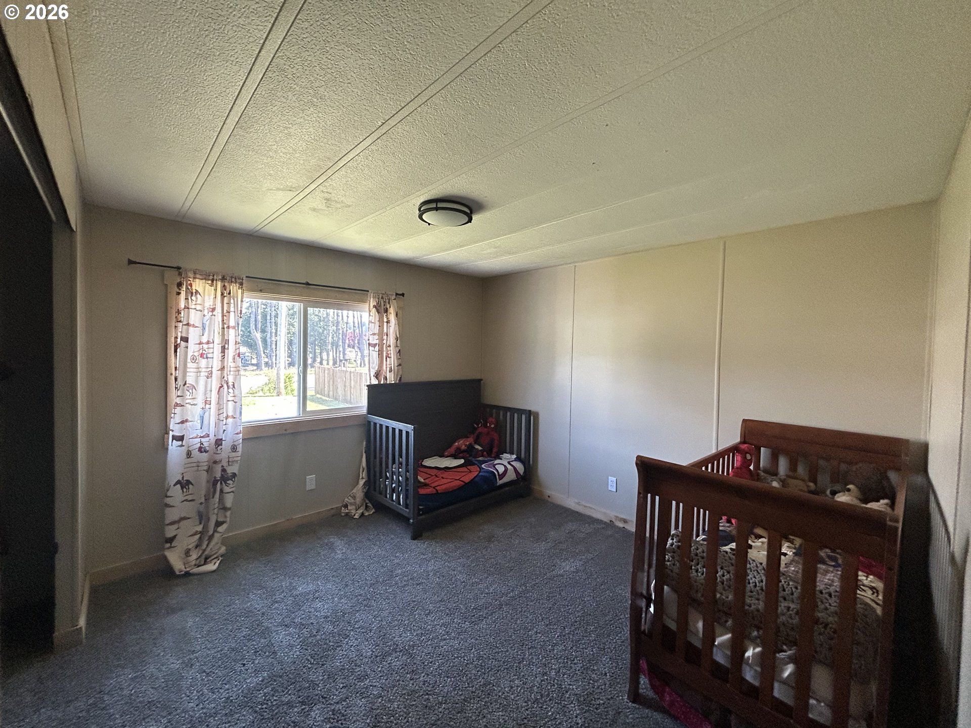 355 North 8th Street Lakeside, OR 97449 - Photo 21 of 22 a bedroom with furniture and a window