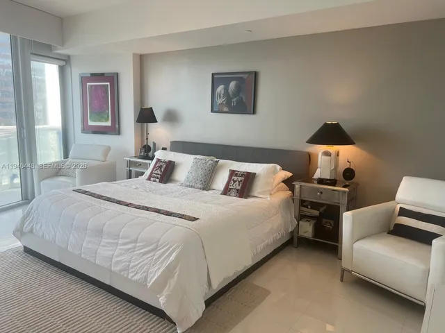 a bedroom with bed and a couch