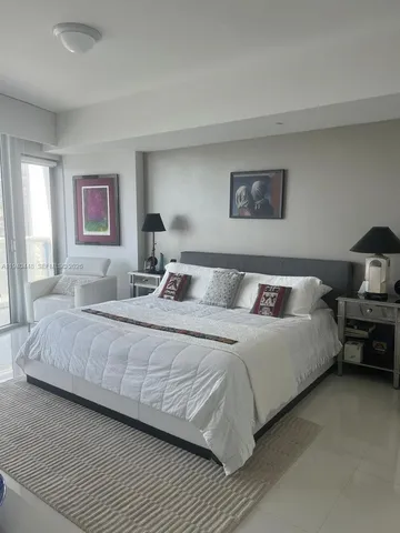 a bedroom with a bed and a couch