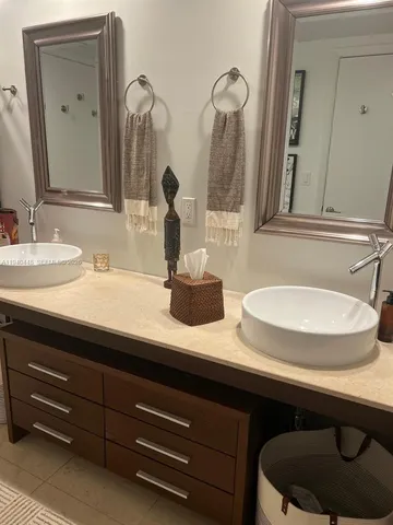 a bathroom with sinks and a mirror