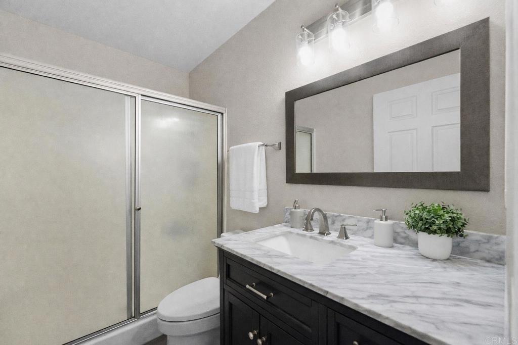 510 Bluffview Road Spring Valley, CA 91977 - Photo 14 of 19 a bathroom with a granite countertop sink a toilet and a mirror