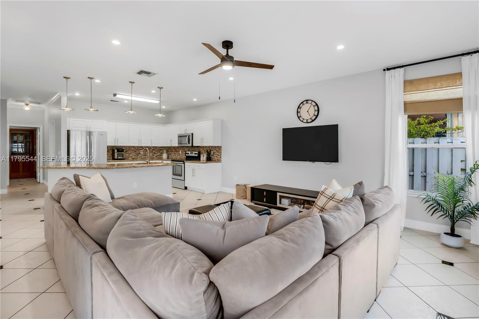 15862 Southwest 24th Street Miramar, FL 33027 - Photo 19 of 61 a living room with furniture kitchen view and a window