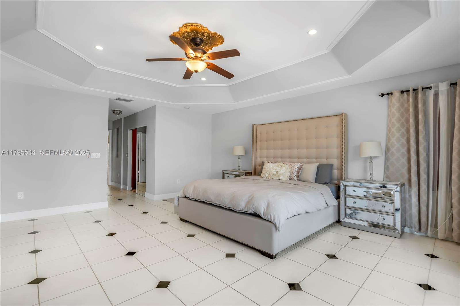 15862 Southwest 24th Street Miramar, FL 33027 - Photo 21 of 61 a bedroom with a large bed and a chandelier