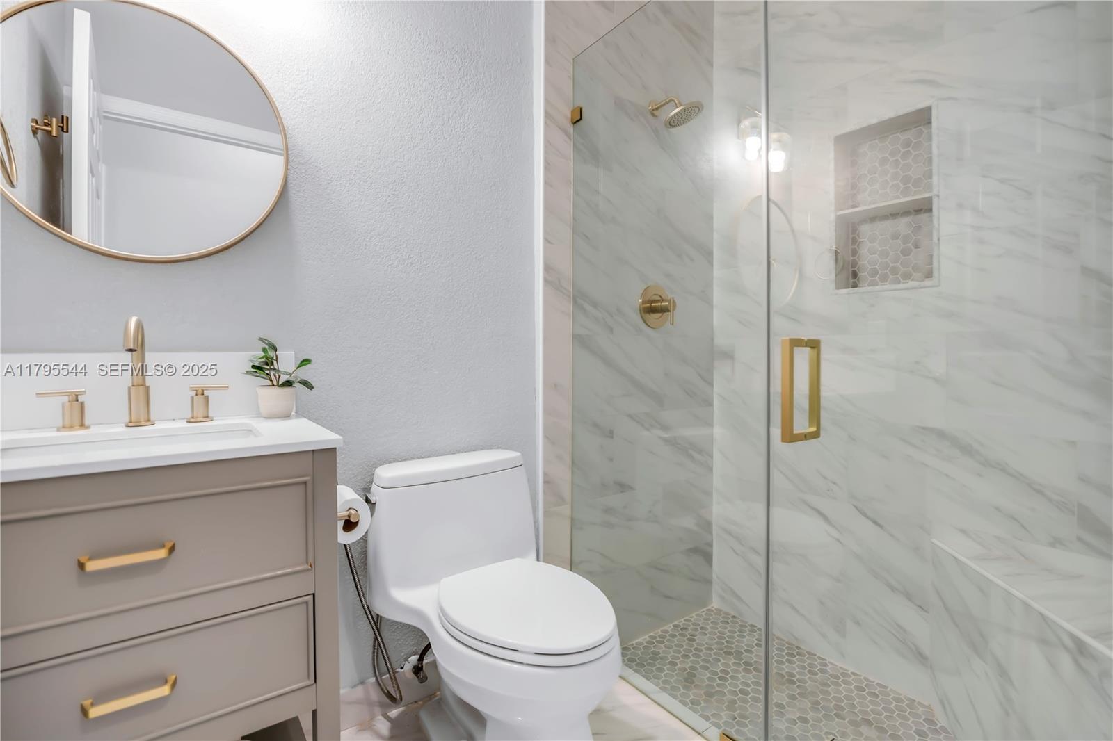 15862 Southwest 24th Street Miramar, FL 33027 - Photo 29 of 61 a bathroom with a sink a toilet and a mirror