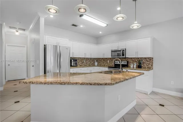 an aerial view of residential houses with outdoor space and lake view