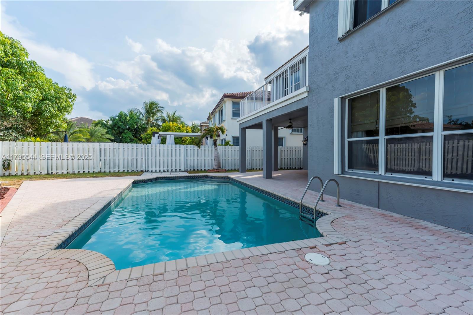 15862 Southwest 24th Street Miramar, FL 33027 - Photo 6 of 61 a view of a swimming pool with a lounge chair