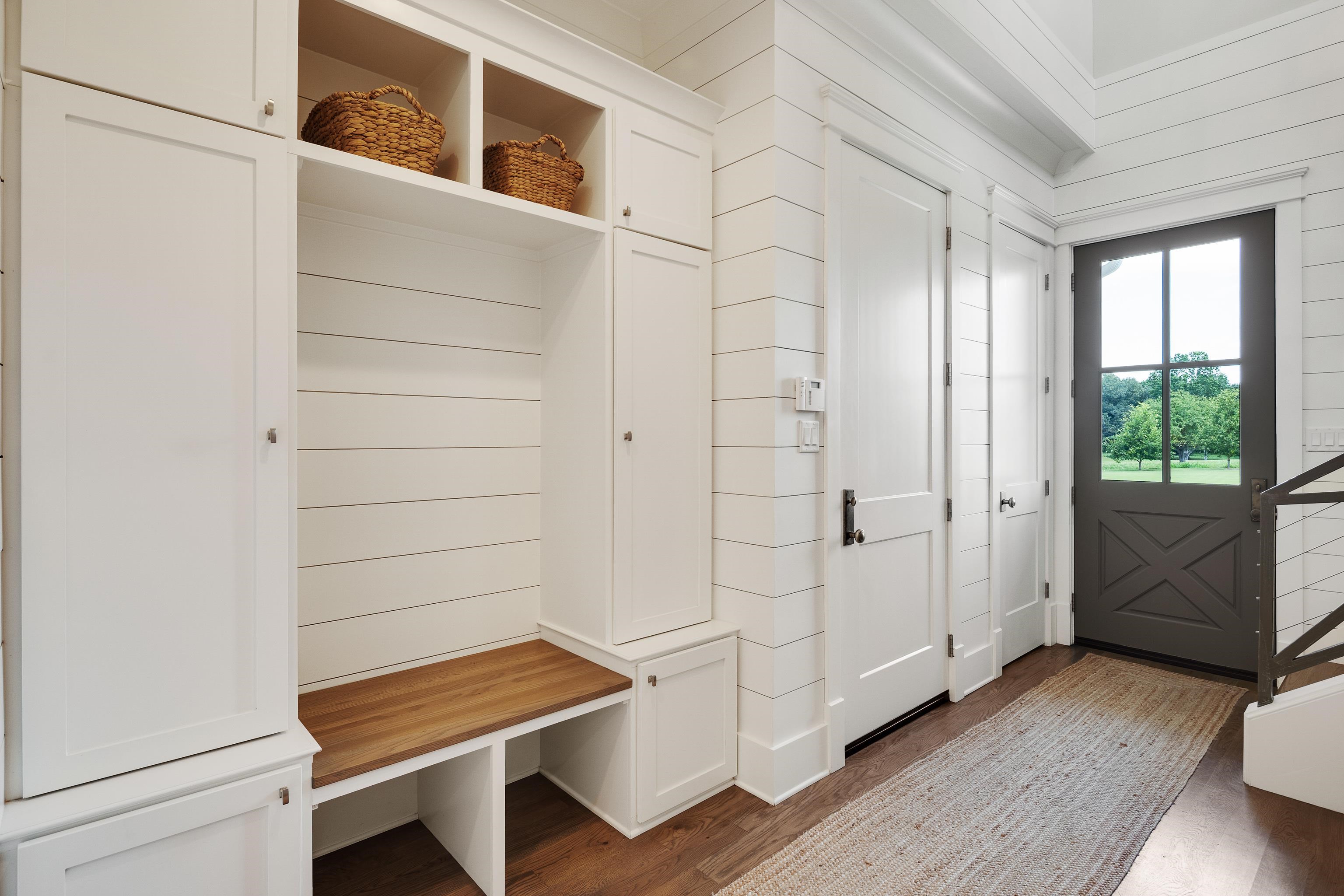 805 Shady Grove Road Williston, TN 38076 - Photo 18 of 40 Entryway featuring shiplap wall paneling, built-in cabinetry with open shelving, a wood-finish bench, and a substantial wood-finish door with glass panels