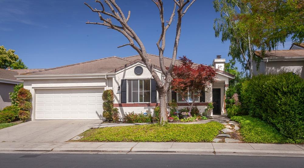 a front view of a house with a yard garage and outdoor seating