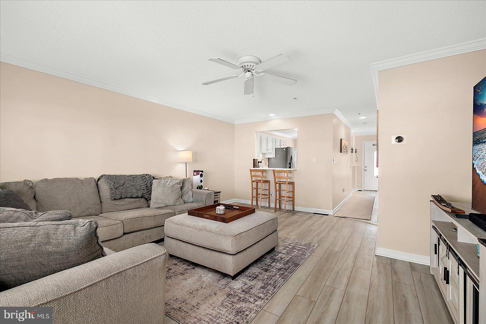 712 Bradley Road, Unit E Ocean City, MD 21842 - Photo 11 of 48 a living room with furniture and a flat screen tv