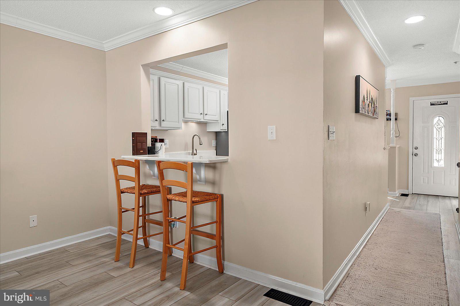 712 Bradley Road, Unit E Ocean City, MD 21842 - Photo 13 of 48 a dining room with furniture and wooden floor