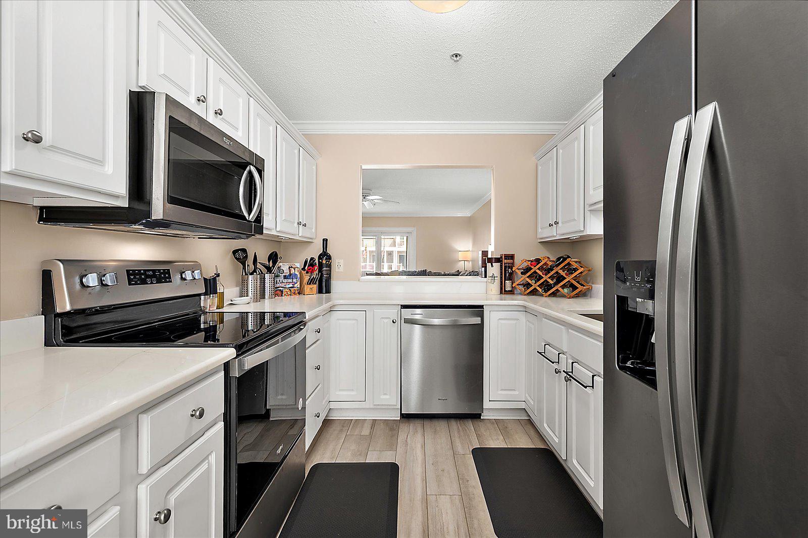 712 Bradley Road, Unit E Ocean City, MD 21842 - Photo 14 of 48 a kitchen with stainless steel appliances a stove microwave and a refrigerator