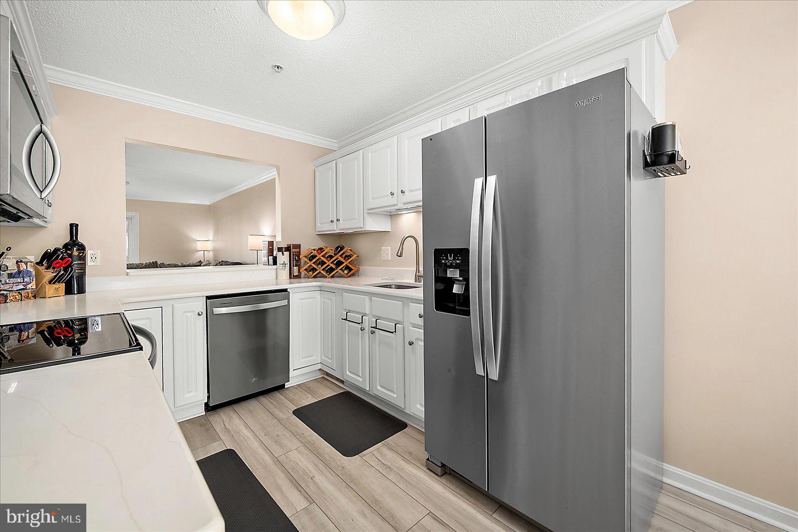 712 Bradley Road, Unit E Ocean City, MD 21842 - Photo 15 of 48 a kitchen with white cabinets and white appliances