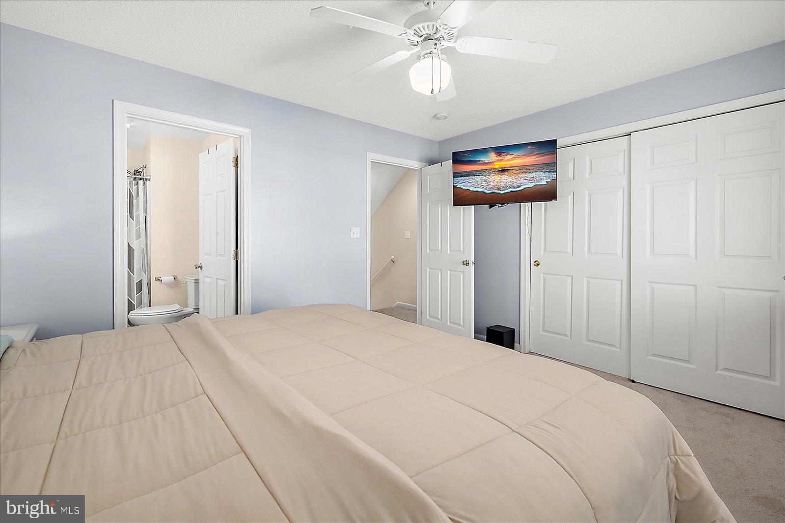 712 Bradley Road, Unit E Ocean City, MD 21842 - Photo 22 of 48 a bedroom with a bed and a chandelier