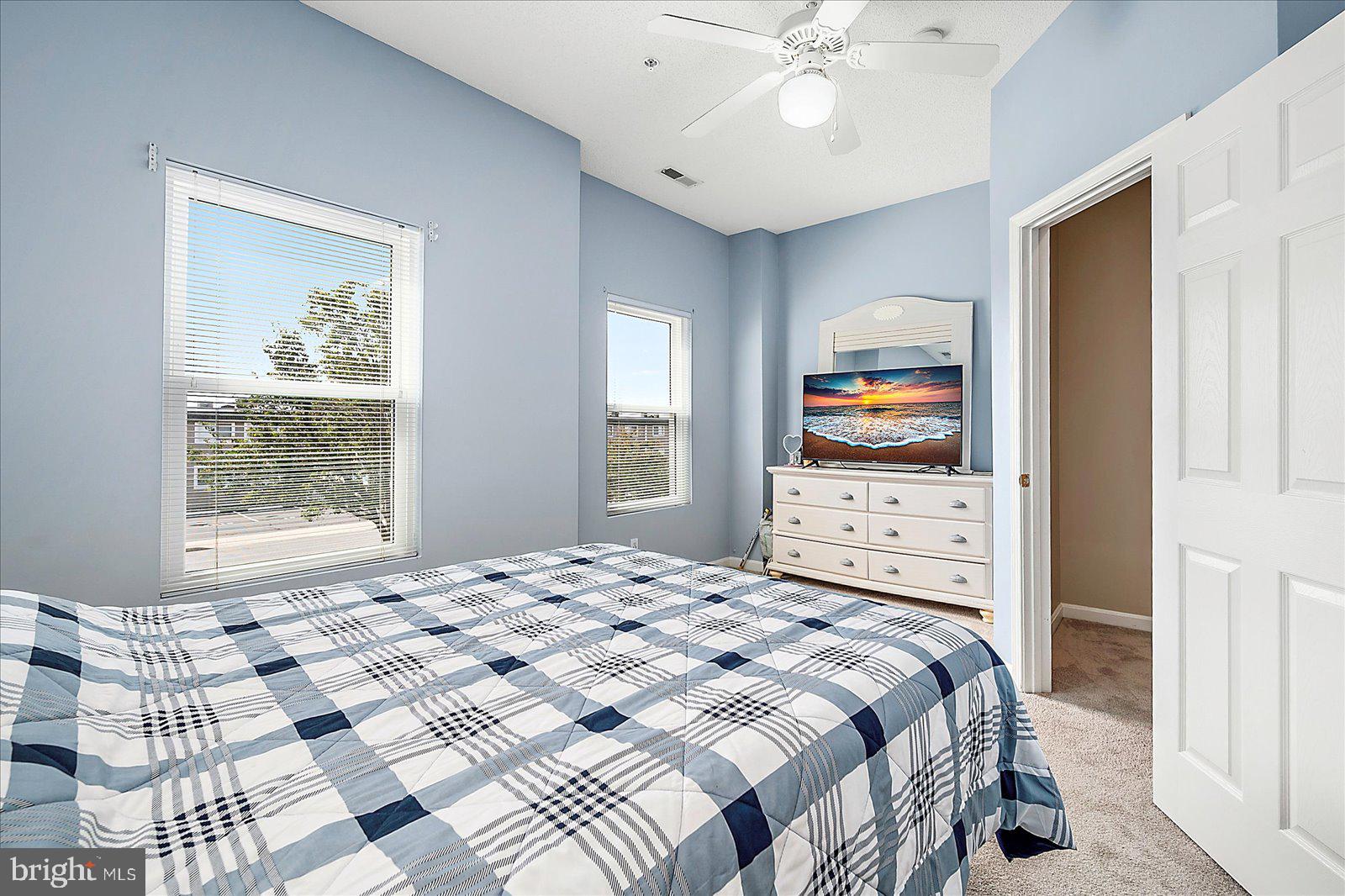 712 Bradley Road, Unit E Ocean City, MD 21842 - Photo 27 of 48 a bedroom with a bed and a television