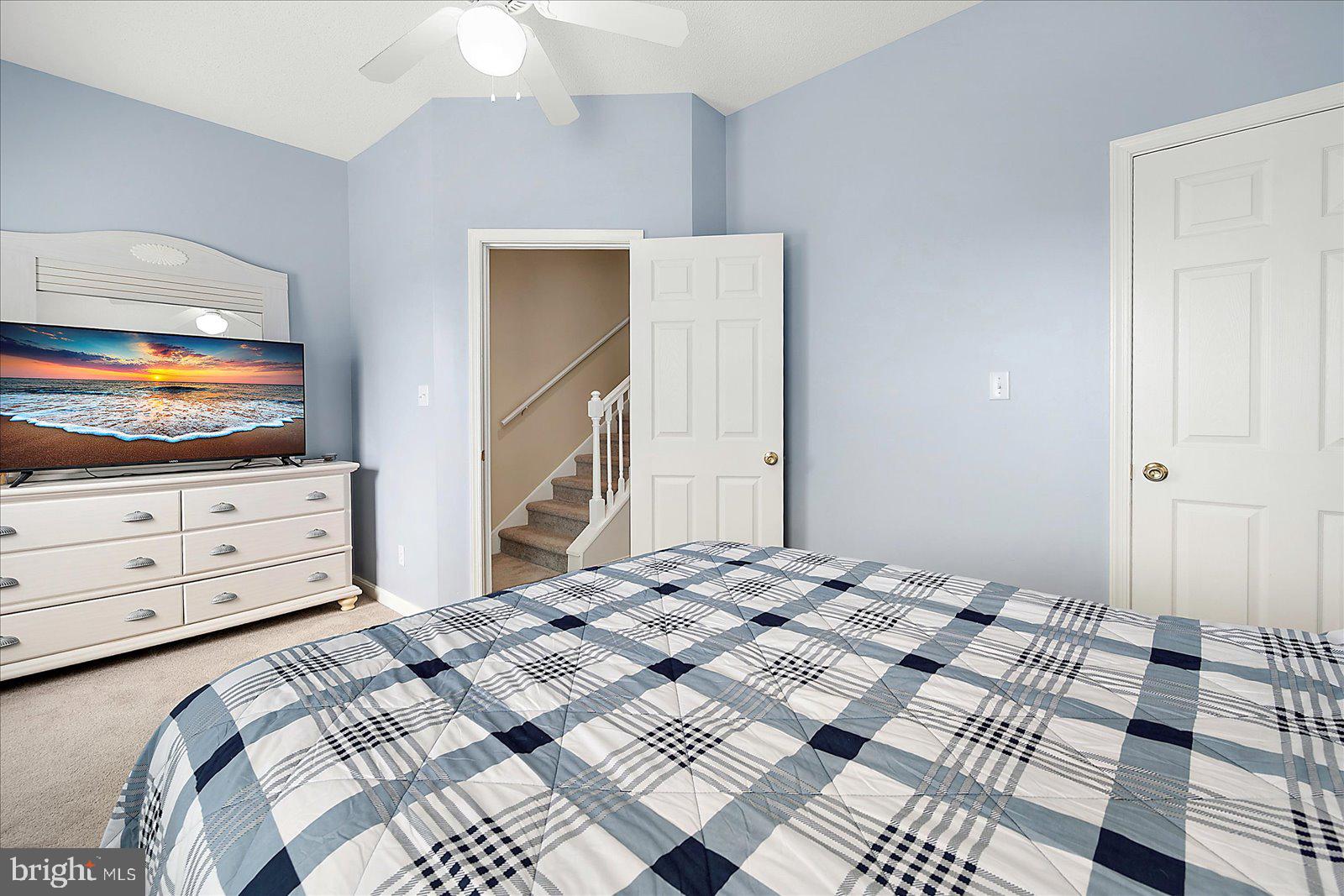 712 Bradley Road, Unit E Ocean City, MD 21842 - Photo 28 of 48 a bedroom with a bed and a flat screen tv