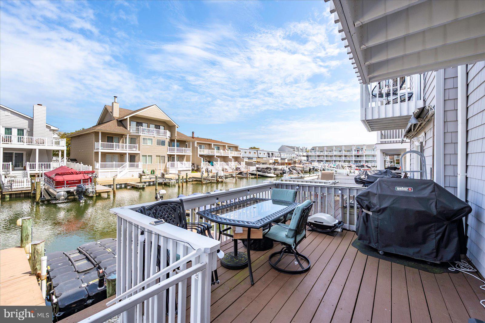 712 Bradley Road, Unit E Ocean City, MD 21842 - Photo 37 of 48 a view of a rooftop deck and couch with wooden floor
