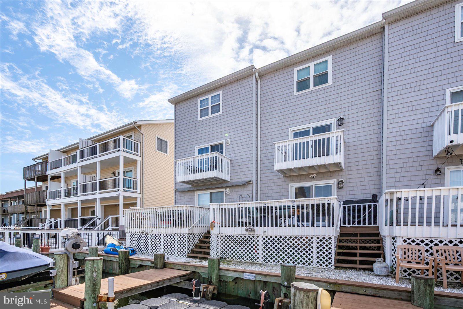 712 Bradley Road, Unit E Ocean City, MD 21842 - Photo 42 of 48 a front view of a house with a garden