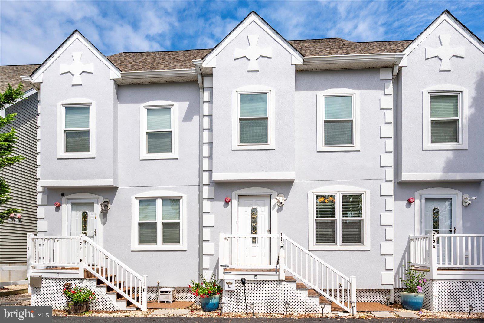 712 Bradley Road, Unit E Ocean City, MD 21842 - Photo 45 of 48 a front view of a residential apartment building with a yard